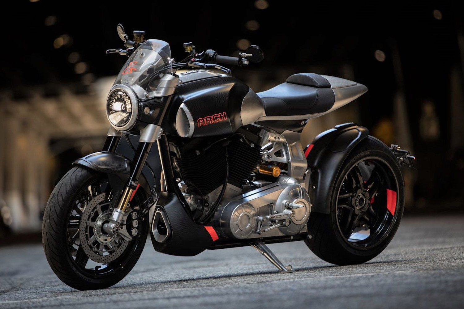 Front end angle of Arch Motorcycle 1s parked on concrete in a tunnel.