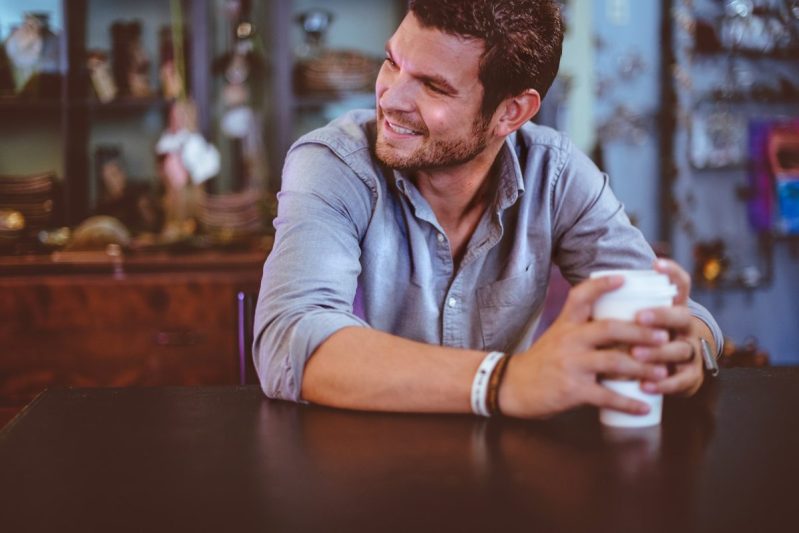 A man sitting drinking coffee.