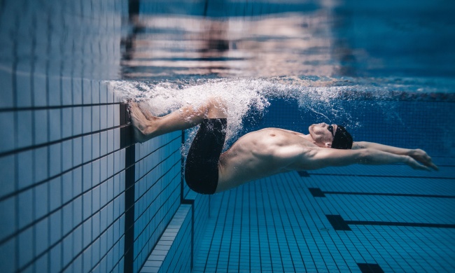 Man swimming in a pool.